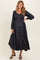 woman wearing a black maternity midi dress with button details and a tiered hem, showcasing her baby bump