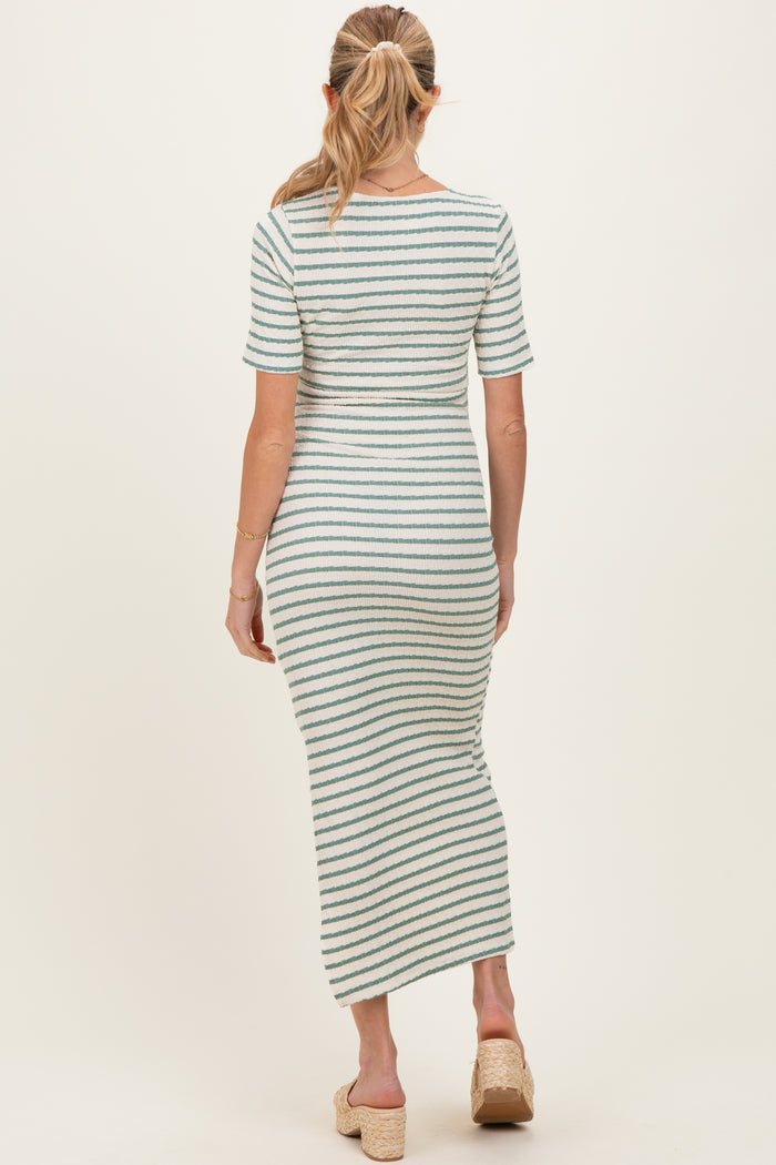 woman wearing a striped maternity maxi dress with short sleeves and a fitted silhouette, showing her back