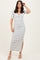 woman wearing a striped midi dress with a twist detail and side slit, posing with one hand on her head