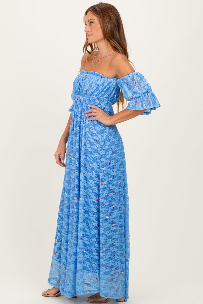 woman wearing a blue off-the-shoulder maxi dress with ruffled sleeves and floral patterns