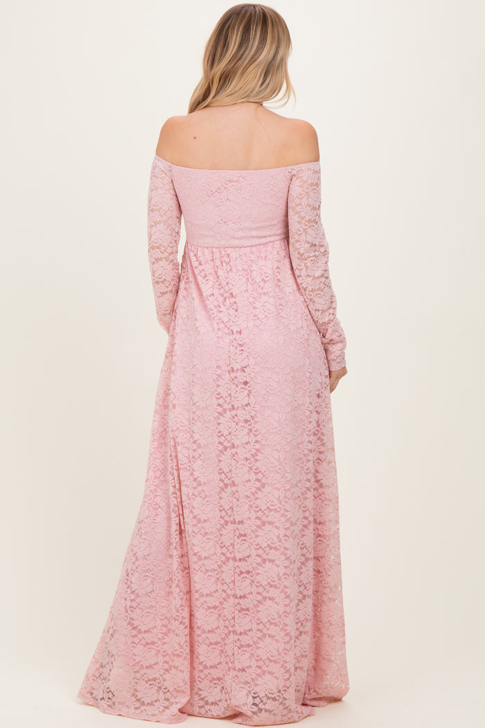 woman wearing a blush pink off-the-shoulder lace maxi dress with long sleeves, seen from the back