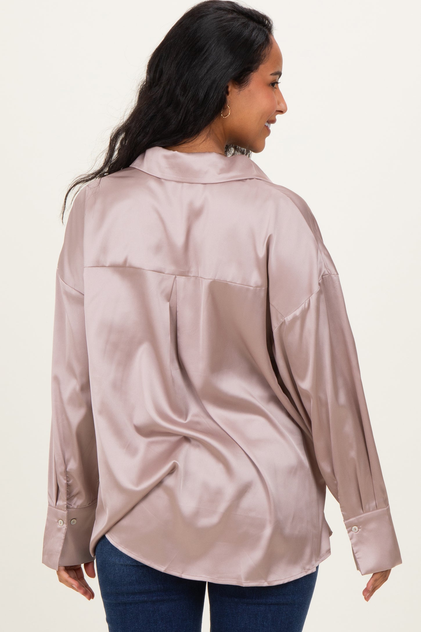 woman wearing a blush satin maternity shirt with a relaxed fit, viewed from the back