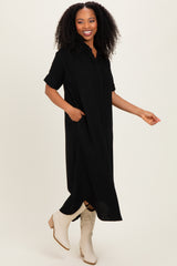 woman wearing a black short sleeve button-up maxi dress with side pockets and beige ankle booties