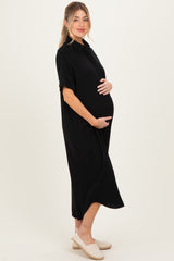 woman wearing a black short sleeve maternity dress and holding her baby bump