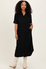 woman wearing a black short sleeve button-up maxi dress with pockets and styled with beige knee-high boots