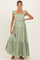 woman wearing a verde green floral embroidered maternity maxi dress with ruffle straps and a fitted bodice