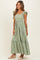 woman wearing a green maxi dress with ruffled sleeves and floral embroidery details