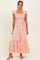 woman wearing a peach maxi dress with floral embroidery and ruffle straps