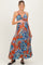 woman wearing a vibrant orange floral maternity maxi dress and holding her baby bump