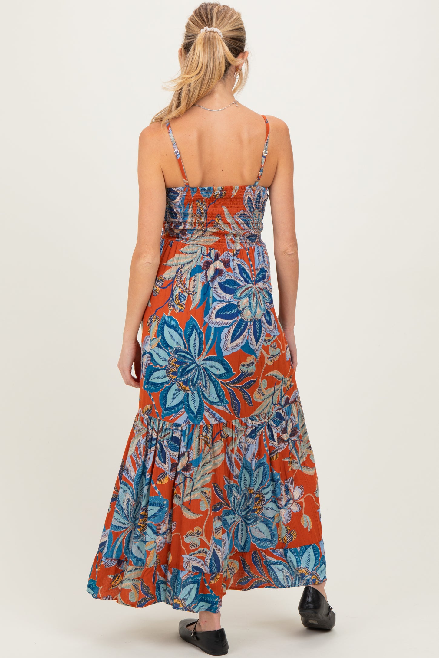 maternity wear orange floral maxi dress with spaghetti straps, showing back view and tiered skirt