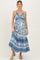 woman wearing a blue floral maternity maxi dress with a tie front detail and a flowing skirt, showcasing her baby bump