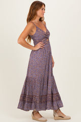 woman wearing a purple paisley print maxi dress with a wrap front and a flared skirt, styled with espadrille wedges