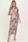 woman wearing a long sleeve tie-dye maternity dress with a fitted silhouette and baby bump visible