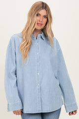 woman wearing a light blue striped oversized button-up shirt with long sleeves