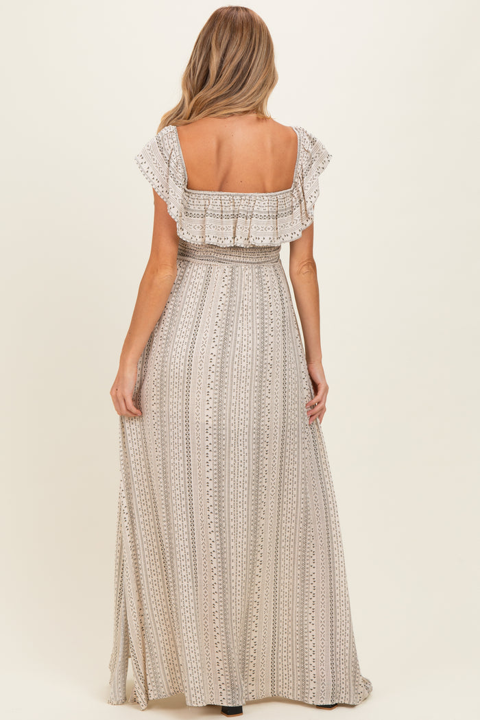 woman wearing a patterned beige maternity maxi dress with ruffled sleeves, viewed from the back
