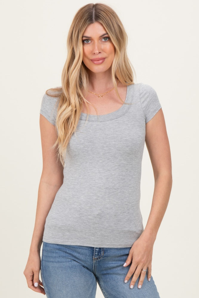 woman wearing a gray ribbed short sleeve top with a square neckline and standing against a neutral background