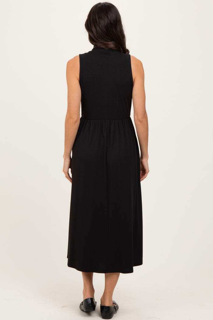 woman wearing a sleeveless black midi dress with a fitted bodice and flared skirt seen from the back