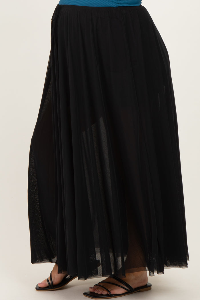 maternity wear black maxi skirt with sheer overlay and side slits, styled with a blue top and black sandals