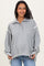 woman wearing a gray maternity pullover with a collar and long sleeves, showing her baby bump