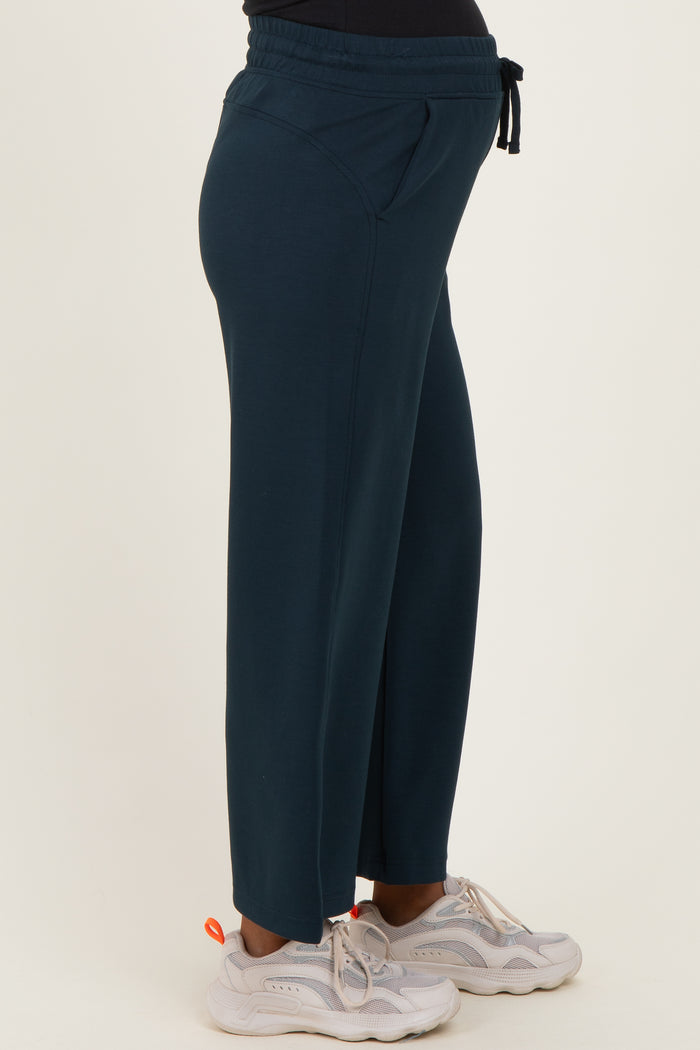 woman wearing navy blue maternity lounge pants with elastic waistband and pockets