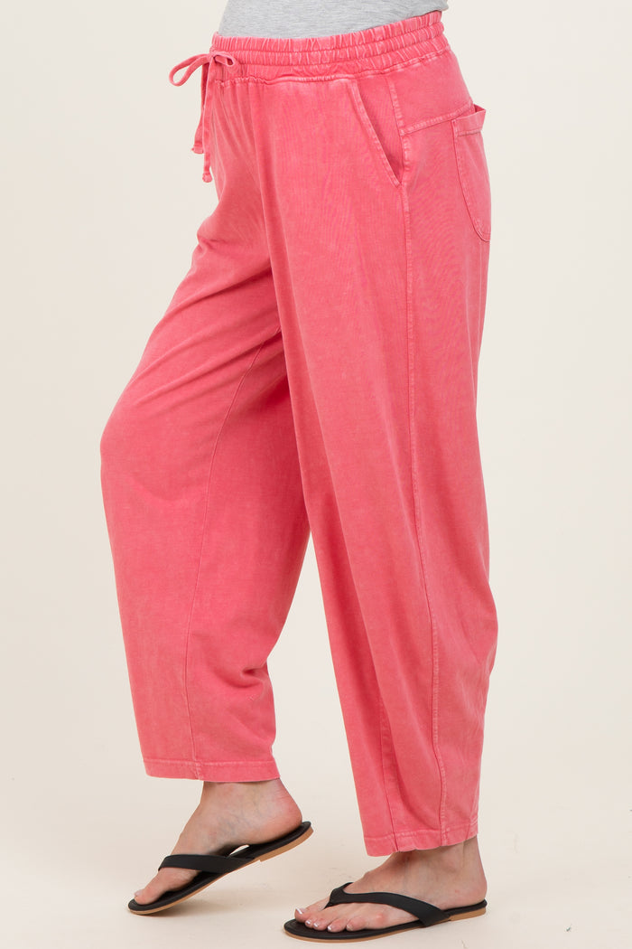 maternity wear in a soft pink color with anelastic waistband and side pockets, styled as loose-fitting pants