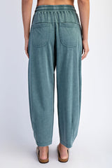 woman wearing light green relaxed fit pants with elastic waistband and two back pockets, seen from the back