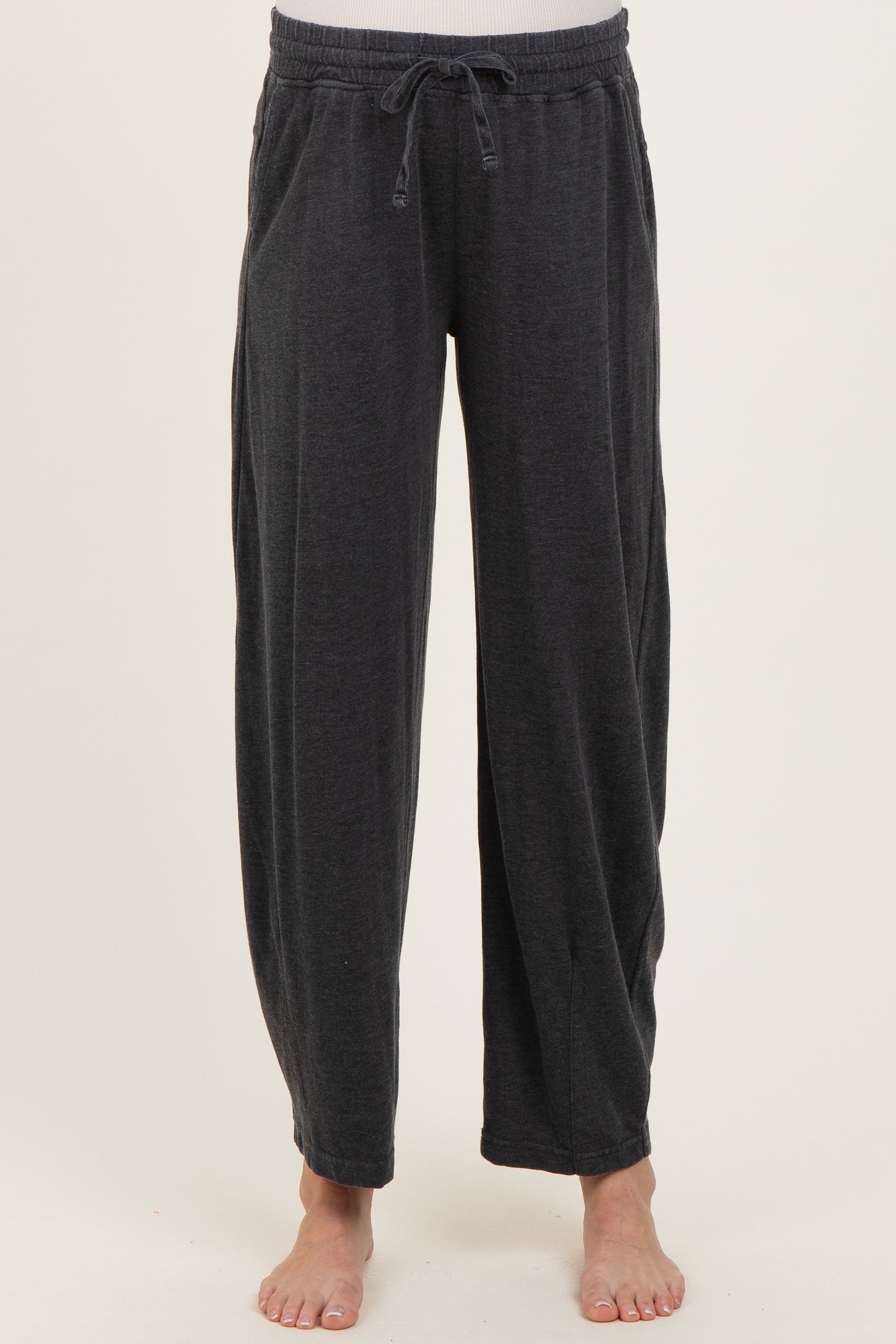 woman wearing dark gray maternity lounge pants with an elastic waistband and side pockets