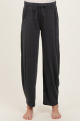woman wearing dark gray maternity lounge pants with an elastic waistband and side pockets