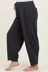 woman wearing dark gray loose fit maternity pants with pockets and an adjustable drawstring waist