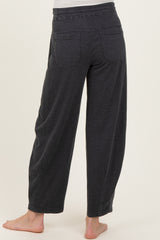 woman wearing black maternity wide-leg pants, showing the back view with elastic waistband and two back pockets