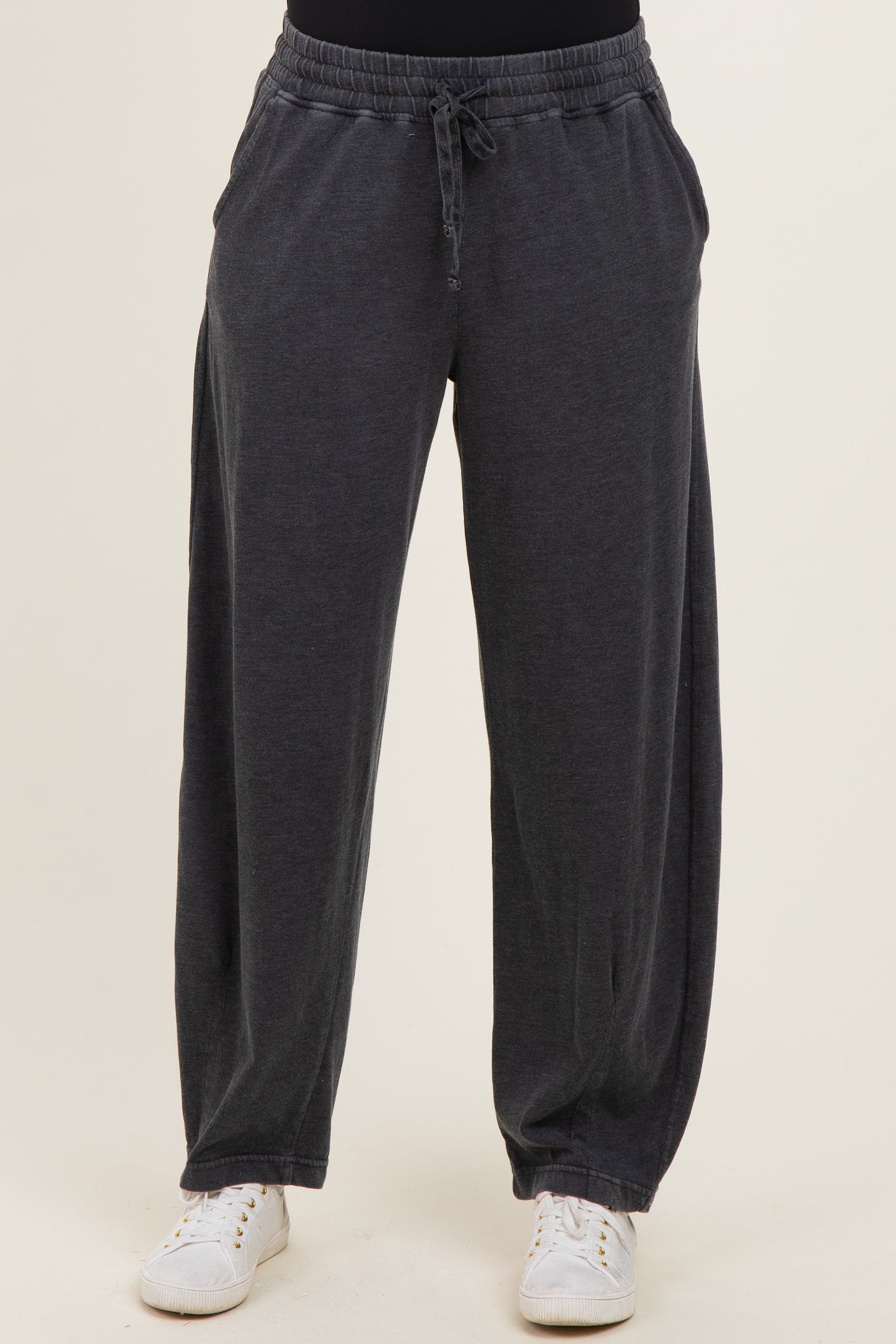 woman wearing dark gray wide-leg lounge pants with an elastic waistband and side pockets