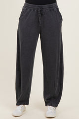 woman wearing dark gray wide-leg lounge pants with an elastic waistband and side pockets