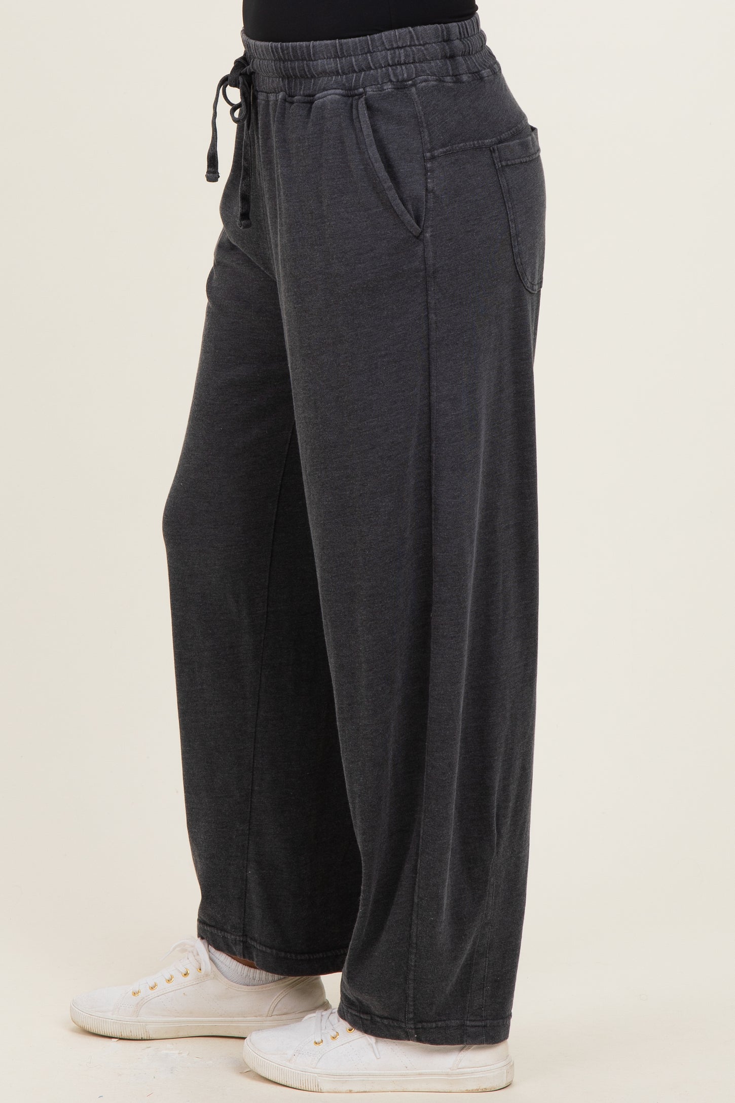 woman wearing relaxed fit charcoal gray wide-leg pants with an elastic waistband and side pockets