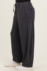 woman wearing relaxed fit charcoal gray wide-leg pants with an elastic waistband and side pockets