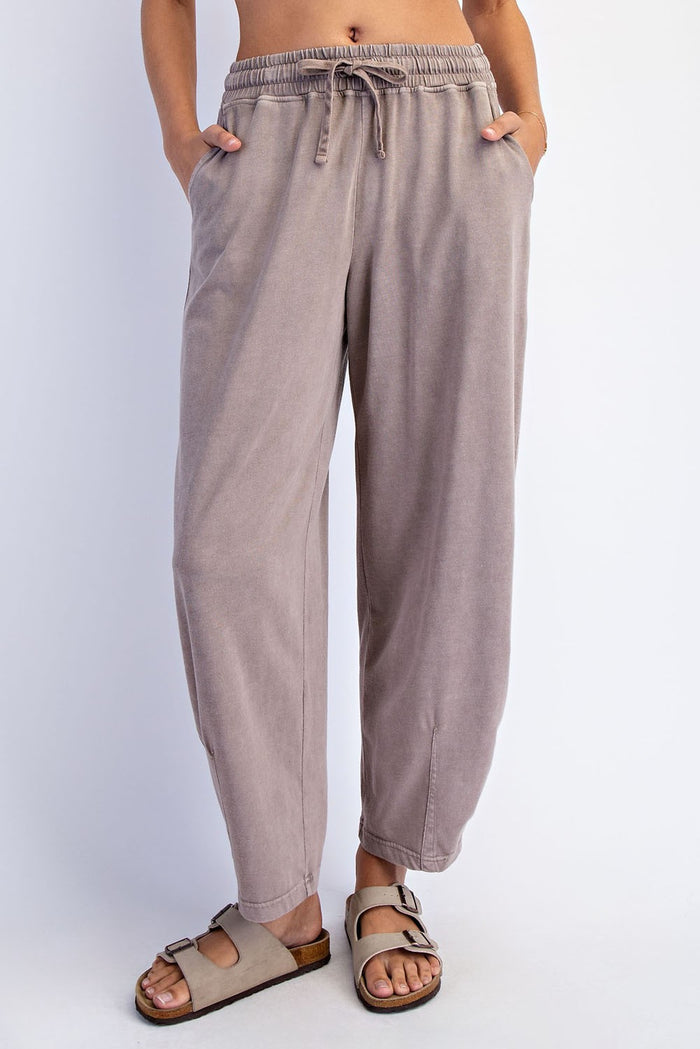 woman wearing light taupe relaxed-fit trousers with an elastic waistband and side pockets