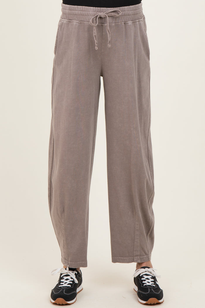 maternity wear in light gray wide-leg pants with an elastic waistband and side pockets, styled with black sneakers