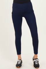 maternity wear navy ribbed leggings with pockets, model wearing black top and athletic shoes