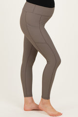 maternity wear taupe high-waisted leggings with seam detailing and a supportive waistband, model showing baby bump