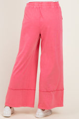woman wearing pink wide leg pants with a relaxed fit and an elastic waistband, shown from the back