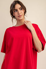 woman wearing a loose-fitting bright red oversized t-shirt with short sleeves