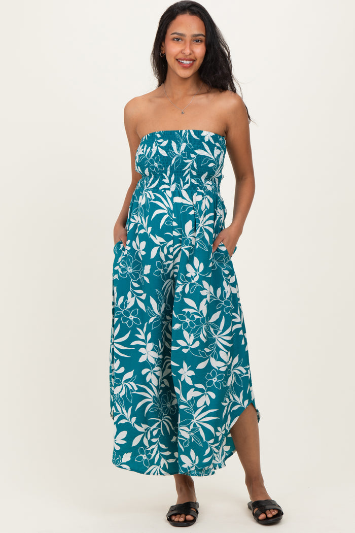woman wearing a strapless teal floral maternity maxi dress with pockets and a fitted bodice, showcasing her baby bump