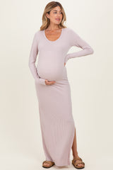 woman wearing a light lavender long sleeve ribbed maternity maxi dress with a side slit and showing her baby bump