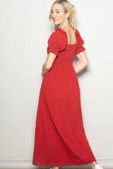 woman wearing a red puff sleeve maxi dress with a square neckline and smocked bodice, shown from the back