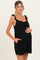 woman wearing a black striped maternity romper with ruffle straps and a baby bump visible