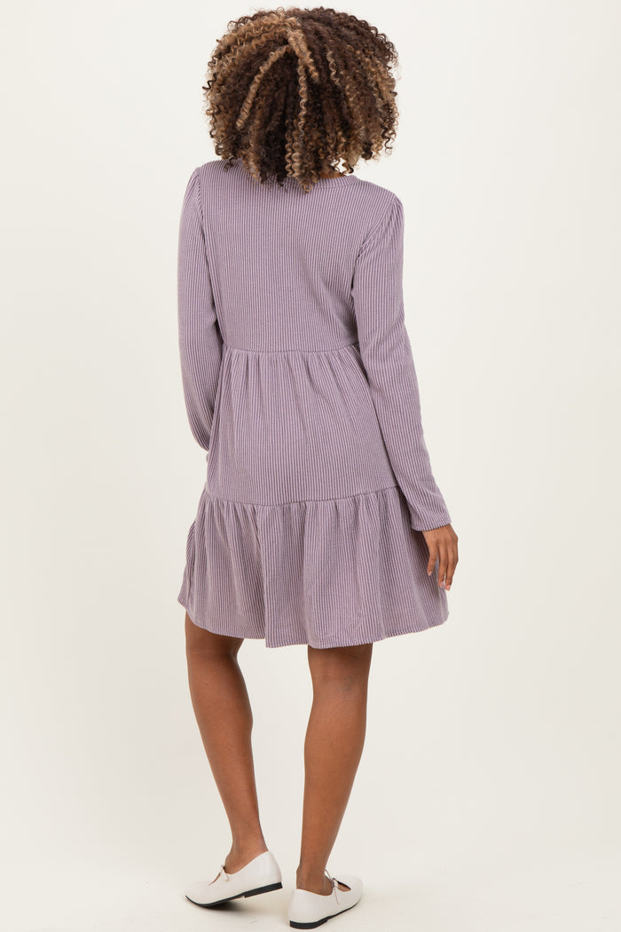 woman wearing a purple striped long sleeve maternity dress with a tiered skirt seen from the back