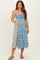 woman wearing a floral midi maternity dress in blue and yellow, holding her baby bump