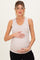 woman wearing a light beige maternity tank top and holding her baby bump