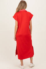 woman wearing a red maternity dress with short sleeves and side slits, viewed from the back
