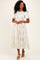 woman wearing a light floral pattern midi dress with short sleeves and a fitted waist, standing on a neutral background