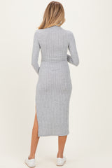 woman wearing a grey ribbed long sleeve maternity dress with a side slit, viewed from the back